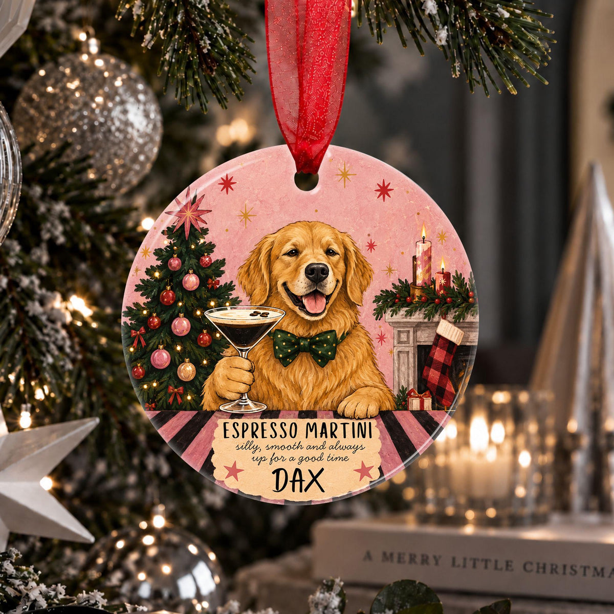 Personalised Golden Retriever Christmas tree decoration hanging from a branch by a deep red ribbon, featuring a smiling Golden Retriever wearing a green bow tie and holding an Espresso Martini beside a decorated Christmas tree and cosy fireplace, with the custom dog name Dax displayed at the bottom.