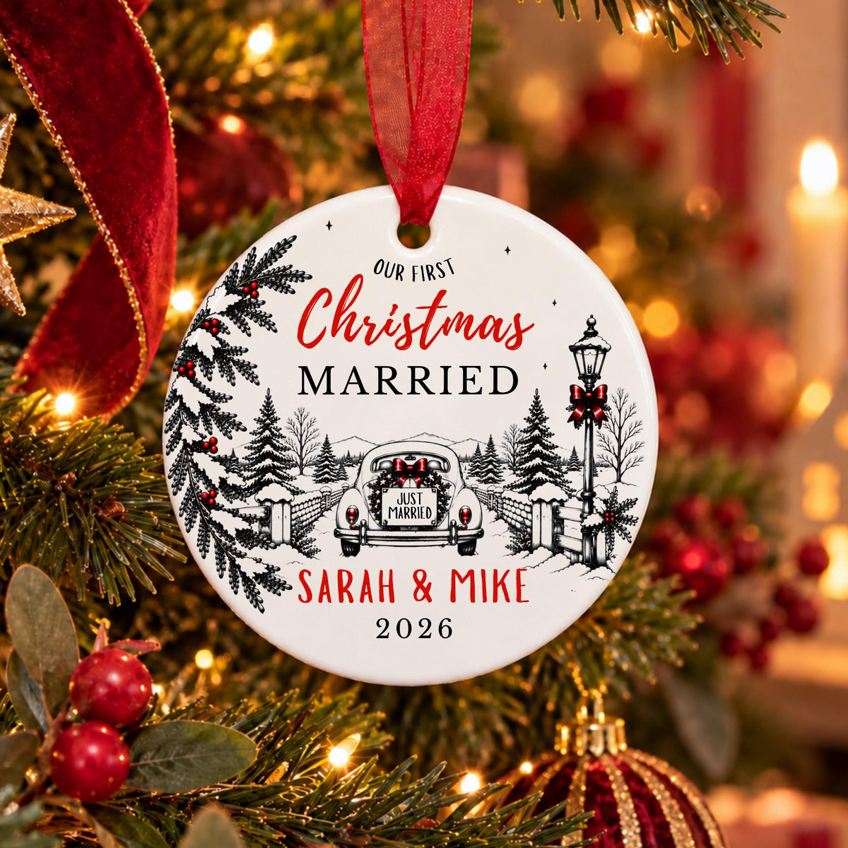 A personalized round Christmas ornament hanging from a red ribbon on a decorated Christmas tree. The white ornament features black line art of a vintage car, trees, and a lamppost, with red and black text reading 'Our First Christmas Married Sarah & Mike 2026'.
