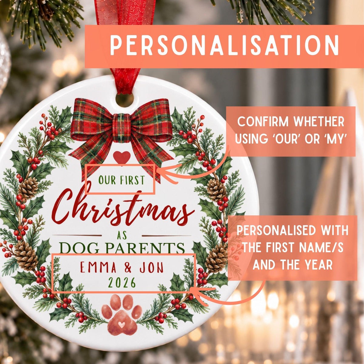 Personalized round Christmas ornament with a red ribbon hanger, featuring a festive wreath design with holly, pinecones, red berries, and a red plaid bow. The ornament includes customizable text such as 'Our First Christmas as Dog Parents Emma & Jon 2026' with a paw print.