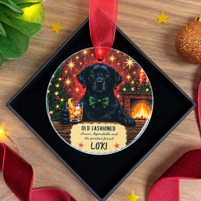 A personalised Christmas ornament with a black Labrador holding an old fashioned cocktail. Personalised with the dogs name