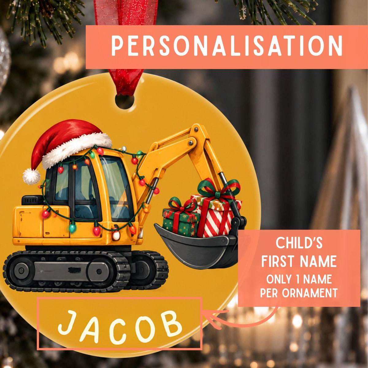 Personalized Christmas ornament featuring a yellow excavator decorated with a red Santa hat and holiday lights, holding a gift box. The ornament has a red hanging ribbon and includes text overlays explaining personalization with the child's first name 'JACOB'.
