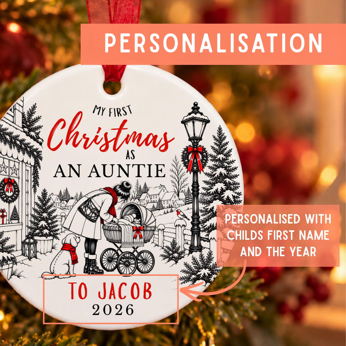 Personalized round Christmas ornament with a festive black-and-white winter village scene and red text reading 'My First Christmas As An Auntie' and 'To Jacob 2026,' shown hanging against a blurred holiday tree background with orange promotional text overlays.