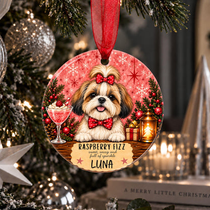 A personalized round Christmas ornament hanging on a decorated tree. The ornament features a printed illustration of a Shih Tzu dog wearing a red bow and bow tie, with the text 'RASPBERRY FIZZ comes with a full of sparkle LUNA'.