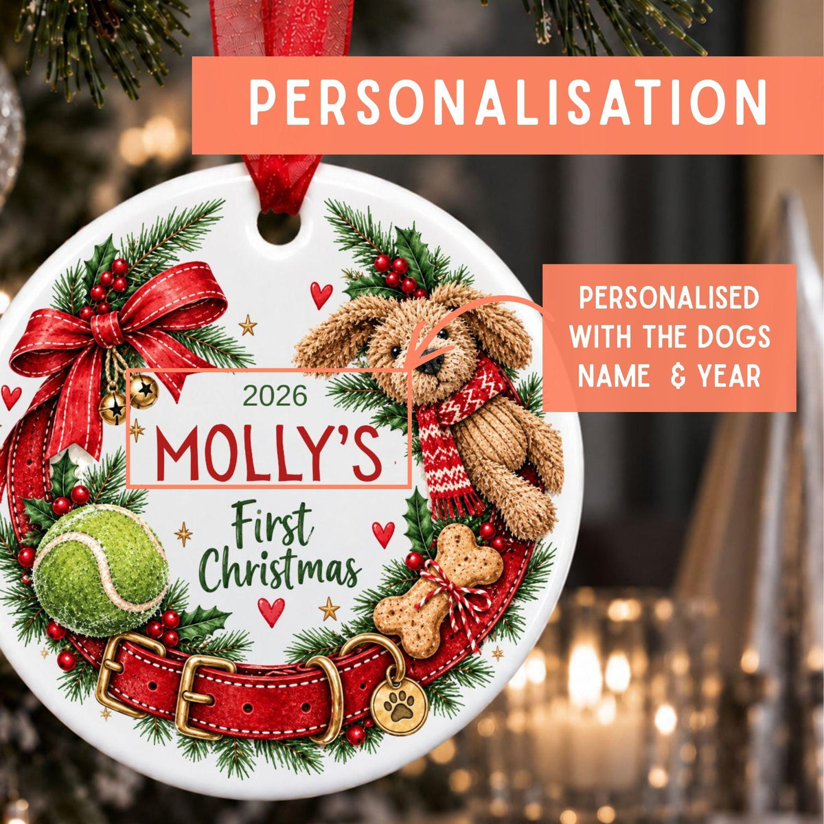 Personalized Christmas ornament featuring a red ribbon, red bow, green pine branches, red collar, tennis ball, dog toy, and a teddy bear wearing a red scarf. The ornament is printed with the text '2026 MOLLY'S First Christmas' and includes promotional text overlays reading 'PERSONALISATION' and 'PERSONALISED WITH THE DOGS NAME & YEAR'.