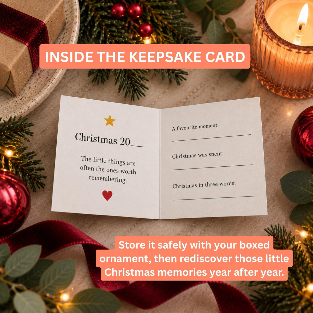 An open keepsake card laid on a tabletop with Christmas decorations around it, including pine branches, red ornaments, a lit candle, and wrapped gift boxes. The card reads 'Christmas 20' and has lines for writing favorite moments, Christmas spent, and Christmas in three words.