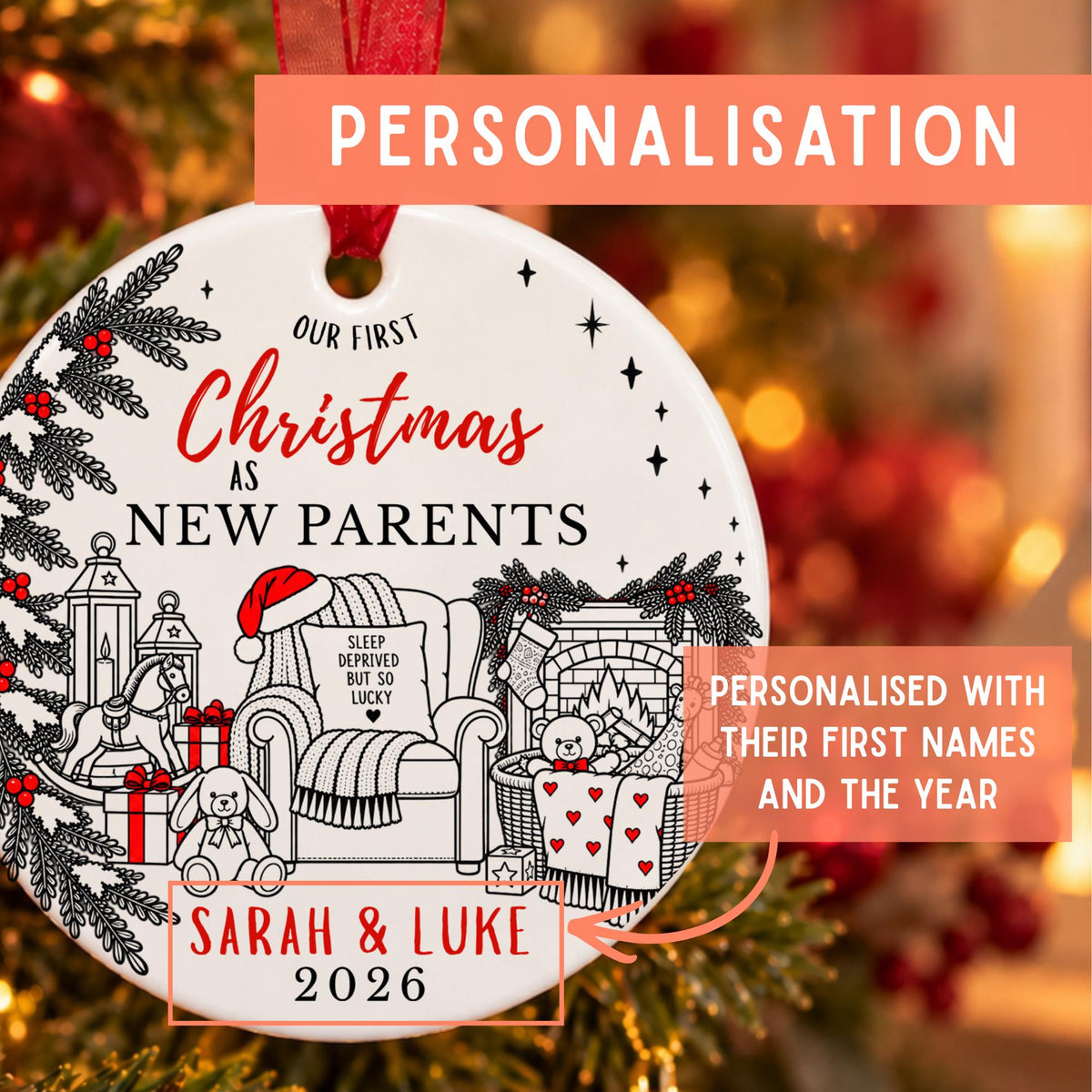 Personalized round Christmas ornament with a red ribbon, featuring black and red text and holiday illustrations including a chair, gifts, bunny, and fireplace. Orange text banners say PERSONALISATION and show example names and year.