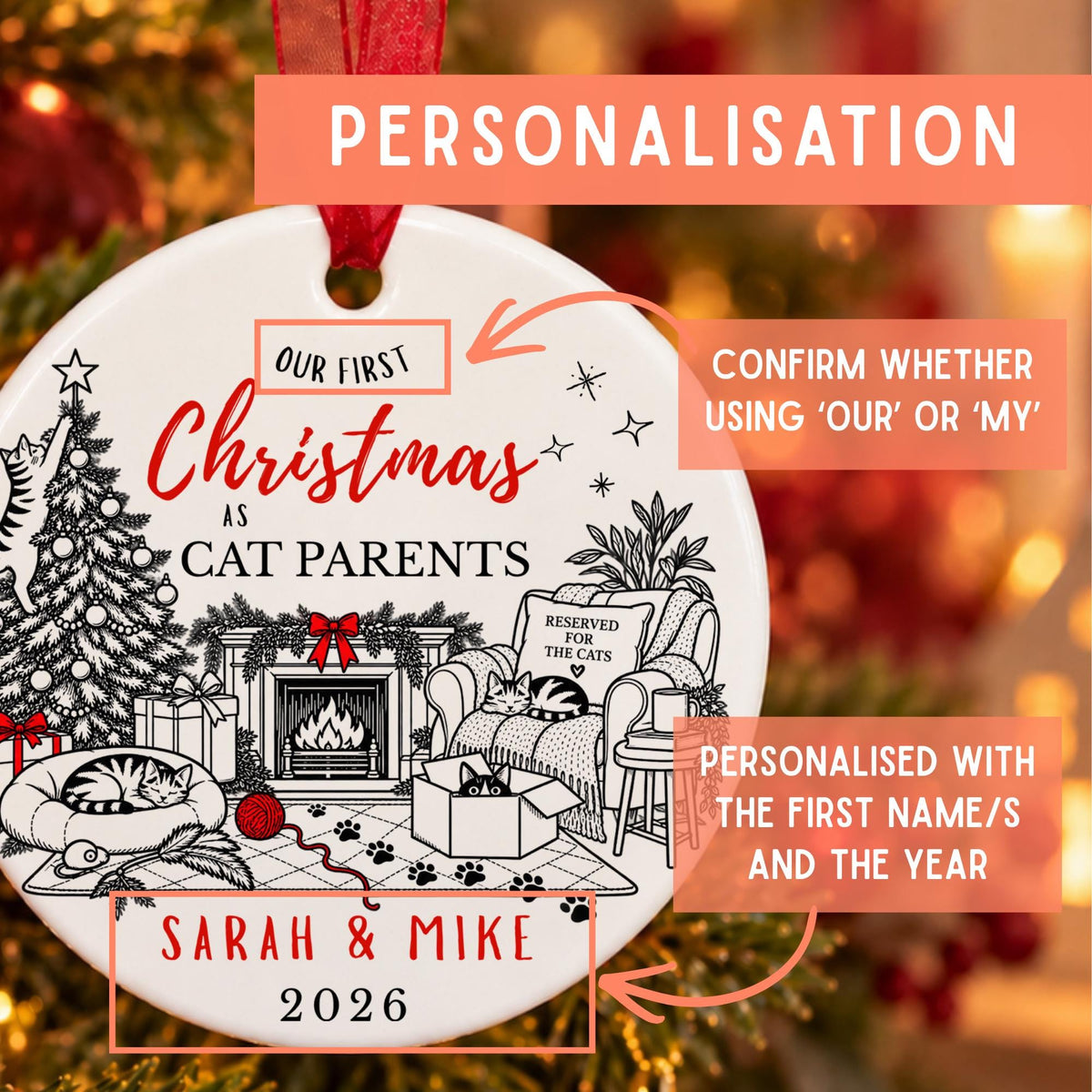 Personalized Christmas ornament with a red hanging ribbon, featuring black line art of a cozy fireplace scene and text reading 'Our First Christmas as Cat Parents' and 'Sarah & Mike 2026'. Orange callout boxes explain personalization options and show the final customized design against a warm blurred holiday background.